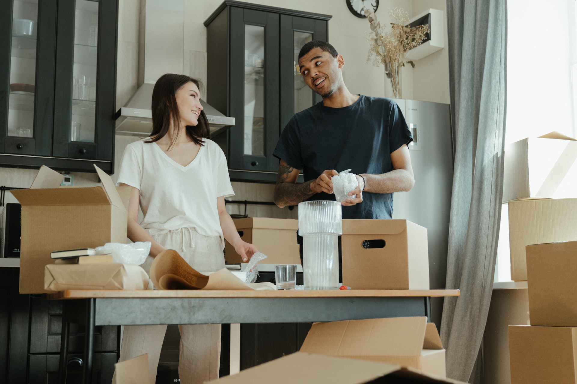 Couple unpacking after moving into a new home