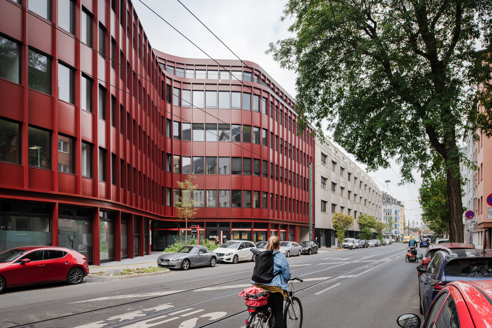 The building is set back from the street and offers space, forming an inviting forecourt.