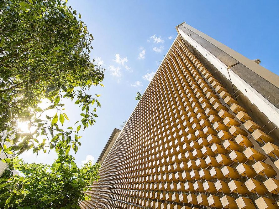 A Wooden Cube Facade Shaped by Light and Order