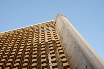 A Wooden Cube Facade Shaped by Light and Order