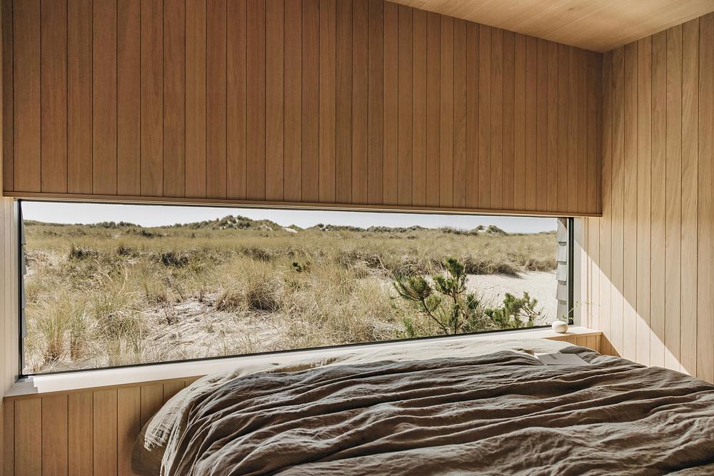 Cedar-Clad Dune House Centers on a Skylit Court