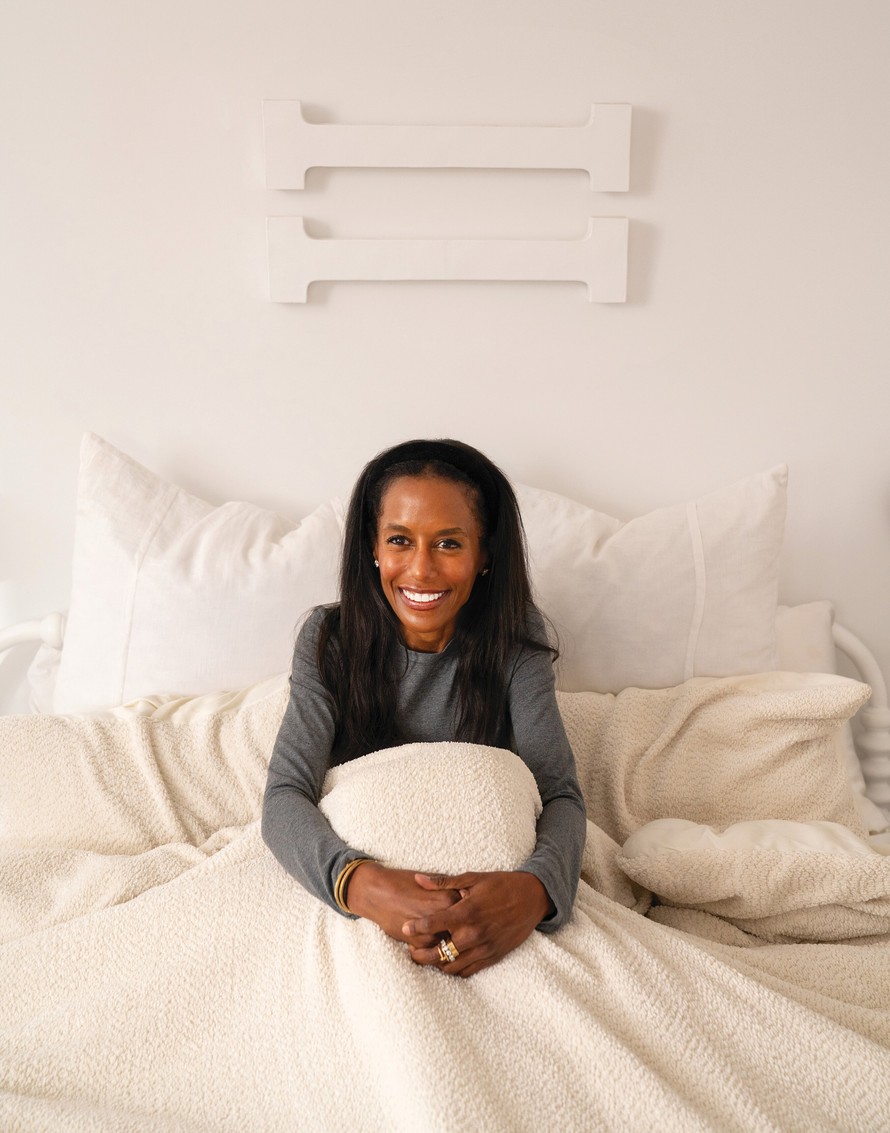 Designer Colette Shelton seated with textured light-colored COCOCOZY bedding