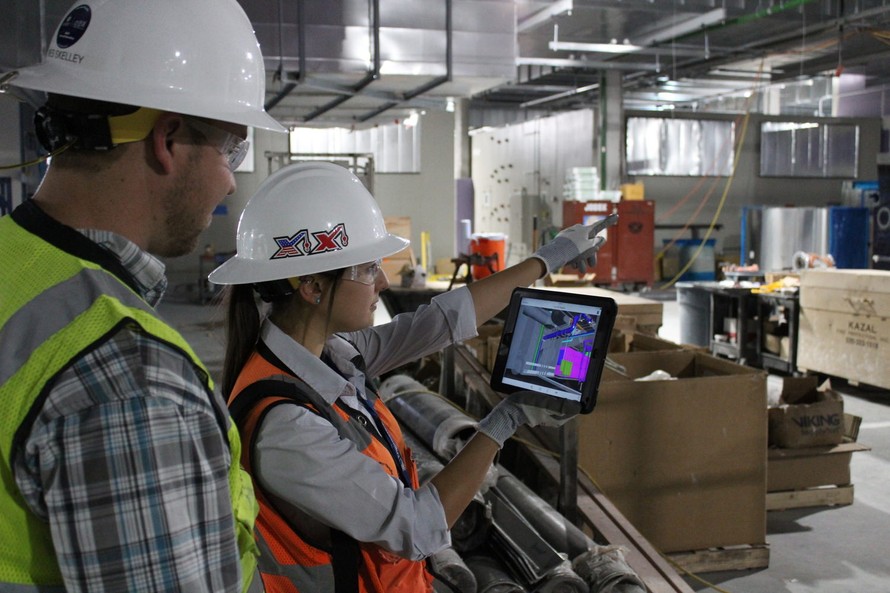 Construction team reviewing information together at a jobsite