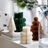 Folded paper decorations in several colors displayed on an IKEA windowsill